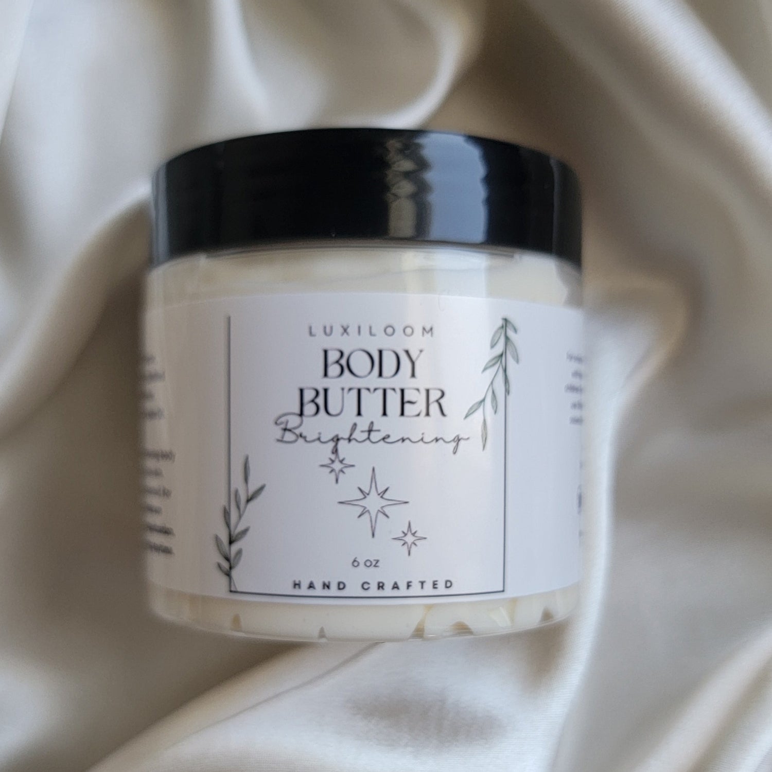 Luxiloom Brightening Body Butter in a glass jar, creamy whipped texture shown with soft lighting – handmade moisturizer with kojic acid and shea butter for glowing, even-toned skin